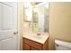 A cozy bathroom features a single sink vanity, a large mirror, and a shower/tub combination at 1086 Wickerwood St, Ocoee, FL 34761