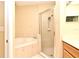 Bathroom featuring a separate tub and glass enclosed shower, providing convenient options at 1086 Wickerwood St, Ocoee, FL 34761