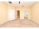 Spacious bedroom featuring plush carpeting, ceiling fan, and access to a walk-in closet and attached bath at 1086 Wickerwood St, Ocoee, FL 34761