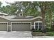 Charming home featuring a three-car garage, well-maintained landscaping, and a welcoming facade at 1086 Wickerwood St, Ocoee, FL 34761