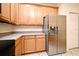 Kitchen with wood cabinets and stainless steel refrigerator at 1086 Wickerwood St, Ocoee, FL 34761