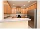 Bright kitchen with stainless steel appliances, light wood cabinets, and stone countertops at 1086 Wickerwood St, Ocoee, FL 34761