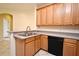 Kitchen featuring wood cabinets, stainless steel sink, and tile flooring at 1086 Wickerwood St, Ocoee, FL 34761