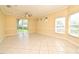 Airy room with tile floor, recessed lights, a ceiling fan, and multiple windows for natural light at 1086 Wickerwood St, Ocoee, FL 34761