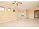 Inviting living space enhanced by tile floors, a ceiling fan, and abundant windows for natural sunlight at 1086 Wickerwood St, Ocoee, FL 34761
