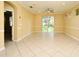 Expansive living area featuring ceramic tile flooring and a ceiling fan, illuminated by natural light at 1086 Wickerwood St, Ocoee, FL 34761