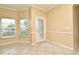 Bright living space with tile flooring, neutral walls, and a glass paneled door to the backyard at 1086 Wickerwood St, Ocoee, FL 34761