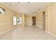 Large living room with ceramic tile flooring and natural light, leading to multiple areas of the home at 1086 Wickerwood St, Ocoee, FL 34761