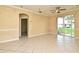 Spacious living area featuring tile floors, neutral paint, and an arched entryway to adjoining room at 1086 Wickerwood St, Ocoee, FL 34761