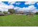 Spacious backyard featuring a pool, a playset, and green lawn, ideal for outdoor activities and enjoyment at 1115 Marni Ridge Ct, Kissimmee, FL 34747