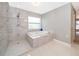 Bathroom featuring shower, soaking tub, and tile at 1115 Marni Ridge Ct, Kissimmee, FL 34747