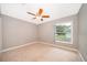 Bedroom featuring neutral carpet, ceiling fan and a window at 1115 Marni Ridge Ct, Kissimmee, FL 34747