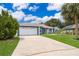 Charming single-story home featuring a well-manicured lawn and a two-car garage at 1115 Marni Ridge Ct, Kissimmee, FL 34747