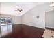 Spacious living room with high ceilings, hardwood floors, and sliding glass doors to the pool at 1115 Marni Ridge Ct, Kissimmee, FL 34747