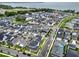 Scenic aerial view of a residential neighborhood with waterfront homes and tree-lined streets near a body of water at 1206 Civitas Way, Winter Garden, FL 34787