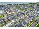 Aerial view of a Primary-planned neighborhood with mature trees and lush lawns near a lake at 1206 Civitas Way, Winter Garden, FL 34787