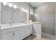 Modern bathroom featuring double sinks, sleek fixtures, a walk-in shower, and contemporary design at 1206 Civitas Way, Winter Garden, FL 34787