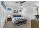 Comfortable bedroom with a tufted headboard, patterned bedding, and bright windows with blue cornices at 1206 Civitas Way, Winter Garden, FL 34787