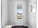 Front door with glass pane and sidelight offering a view of the home's exterior and landscaping at 1206 Civitas Way, Winter Garden, FL 34787