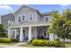 Charming two-story home with a welcoming front porch, manicured landscaping, and a light gray exterior at 1206 Civitas Way, Winter Garden, FL 34787