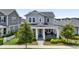 Inviting two-story home featuring a covered front porch, blue door, well-kept lawn, and established landscaping at 1206 Civitas Way, Winter Garden, FL 34787