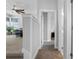 Upstairs hallway with carpet flooring, access to the bedroom and bathroom, and natural light through the house at 1206 Civitas Way, Winter Garden, FL 34787