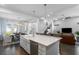 Bright, open-concept kitchen features a large island with a farmhouse sink and stainless steel appliances at 1206 Civitas Way, Winter Garden, FL 34787