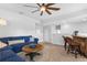Spacious living area featuring a comfortable blue sofa, bar, and ceiling fan at 1206 Civitas Way, Winter Garden, FL 34787