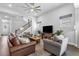 Spacious living room with stairs, a ceiling fan, ample seating, and natural light at 1206 Civitas Way, Winter Garden, FL 34787
