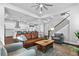 Open concept living room with hardwood floors, stylish furniture, and ample natural light with open stairs at 1206 Civitas Way, Winter Garden, FL 34787