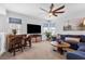 Stylish living room with a ceiling fan, wet bar, comfortable seating and large windows at 1206 Civitas Way, Winter Garden, FL 34787