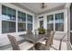 Inviting covered patio featuring a dining table, woven chairs, and view of the backyard at 1206 Civitas Way, Winter Garden, FL 34787