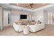 Comfortable living room showcases a modern aesthetic with a stylish ceiling fan and an entertainment center at 1389 Zesty Citrus Ln, Minneola, FL 34715
