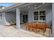Covered patio with wood table and chairs and an outdoor lounge area at 1389 Zesty Citrus Ln, Minneola, FL 34715