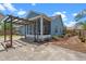 Backyard showcasing a screened porch, pergola, and neatly landscaped area at 1407 S Palmetto Ave, Sanford, FL 32771