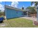 Quaint backyard featuring a brick patio, pergola, and blue exterior paint at 1407 S Palmetto Ave, Sanford, FL 32771