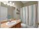 Cozy bathroom featuring a vanity with a sink and a shower with a striped curtain at 1407 S Palmetto Ave, Sanford, FL 32771