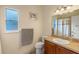 Well-lit bathroom featuring a sink, toilet, and shower with frosted window at 1407 S Palmetto Ave, Sanford, FL 32771