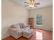Living room with sofa, ottoman, bookshelf, window and red wooden floor at 1407 S Palmetto Ave, Sanford, FL 32771