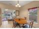 Dining room with wood table set and view to the living room and fenced yard at 1407 S Palmetto Ave, Sanford, FL 32771