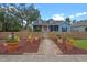 Charming blue two-story home with a picket fence and beautifully landscaped front yard at 1407 S Palmetto Ave, Sanford, FL 32771