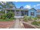 Charming blue two-story home with a screened front porch and landscaped front yard at 1407 S Palmetto Ave, Sanford, FL 32771