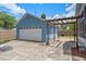 Detached blue garage with pergola and driveway at 1407 S Palmetto Ave, Sanford, FL 32771
