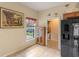 A view of the kitchen with wood cabinets, a window, and a black refrigerator at 1407 S Palmetto Ave, Sanford, FL 32771