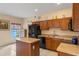 Kitchen with brown cabinets, a center island, and black appliances at 1407 S Palmetto Ave, Sanford, FL 32771