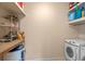Bright laundry area with shelving, appliances, and countertop space for convenience at 1407 S Palmetto Ave, Sanford, FL 32771
