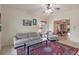 Comfortable living room featuring tile floors, a ceiling fan, and view into the dining area at 1407 S Palmetto Ave, Sanford, FL 32771