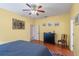 Main bedroom featuring hardwood floors, a ceiling fan, and a black dresser at 1407 S Palmetto Ave, Sanford, FL 32771
