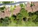 Aerial view of the residential neighborhood with mature trees, manicured lawns, and brown rooftops at 154 Golf Club Dr # 154, Longwood, FL 32779