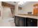 Bathroom with a granite countertop vanity and shower with glass doors and decorative curtains at 154 Golf Club Dr # 154, Longwood, FL 32779